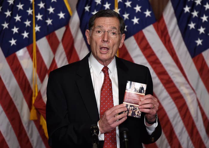 Barrasso holds up a copy of the US Constitution