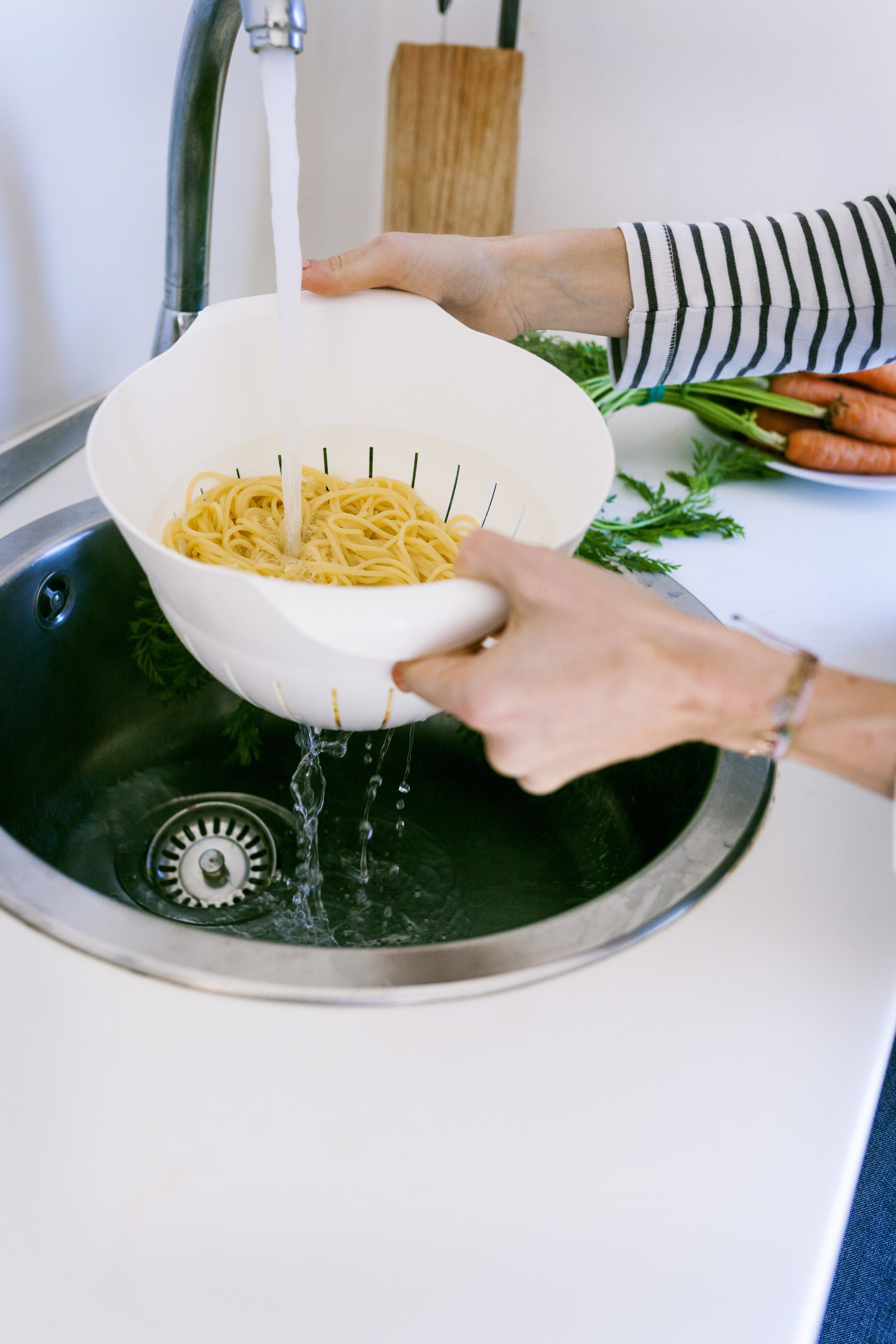 Woman rinsing pasta