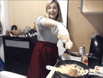 Gif of woman seasoning food in a pan