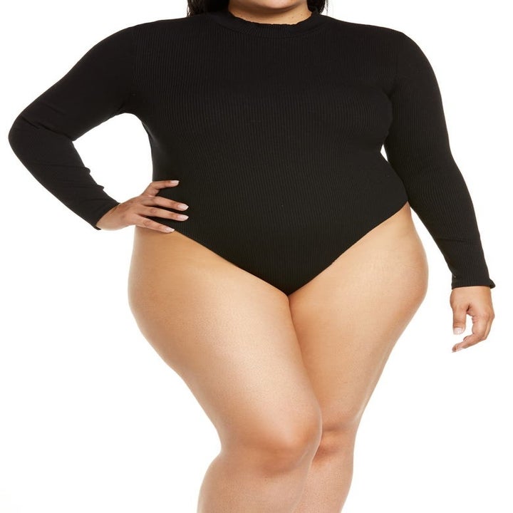 model wearing black bodysuit 