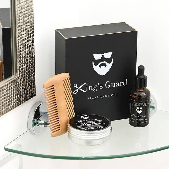 A double sided comb, beard balm, and beard oil together with their gift box