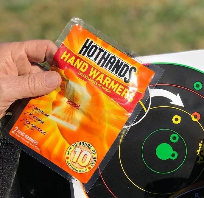 A person holding pack of handwarmers