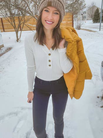 Reviewer wearing the top with three buttons in the center in white