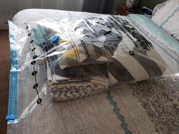 reviewer image of a spacesaver vacuum storage bag full of blankets