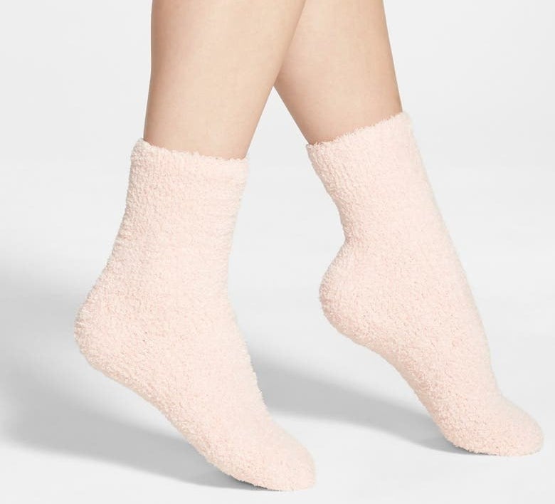 model wearing the pink fuzzy socks