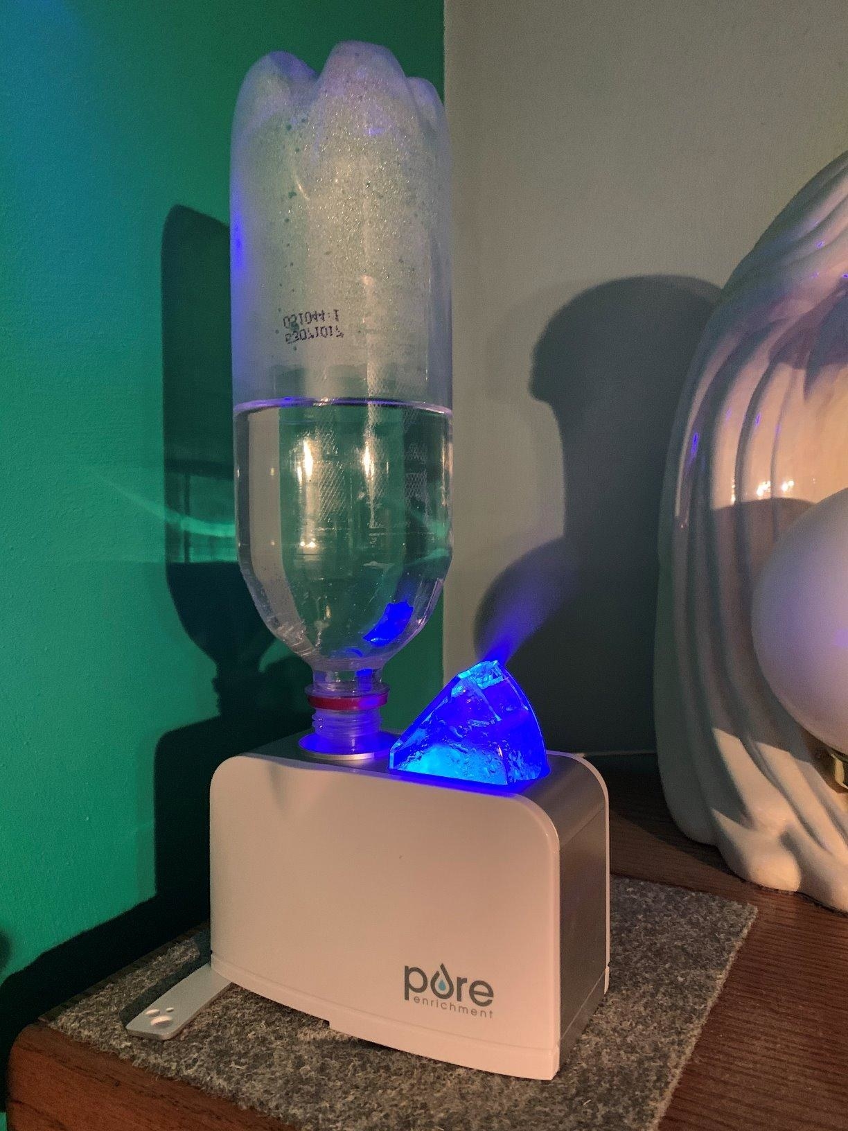 reviewer photo showing water bottle humidifier on nightstand 