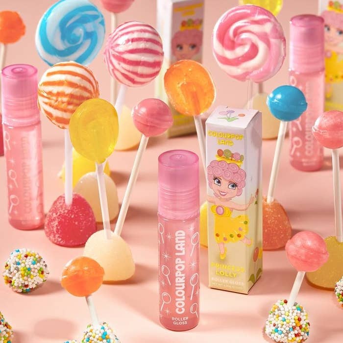 pink glittery lip balm that has white illustrated lollipops on it next to box with lollipop princess on it 