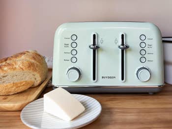 A reviewer's photo of the four-slice toaster in cozy greenish