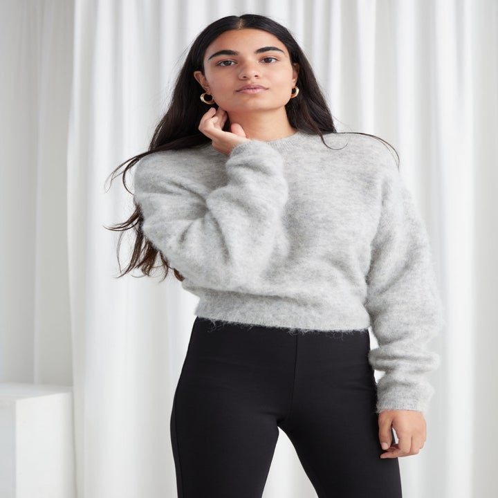 model in fuzzy grey long sleeve sweater