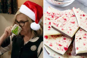 a woman drinking out of a mug wearing a santa hat next to a pile of peppermint bark