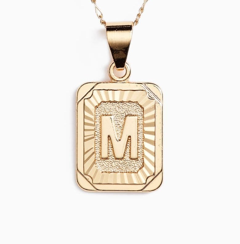 The rectangular pendant with the letter M