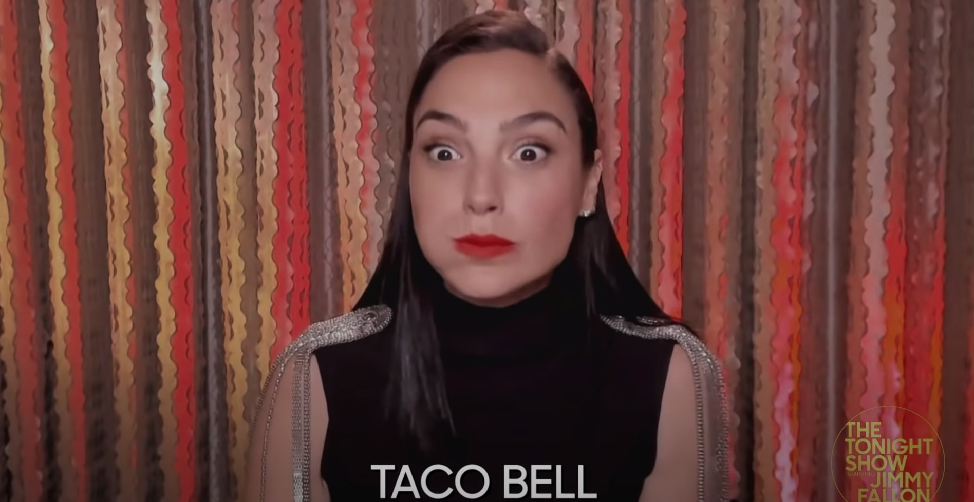 Gal Gadot wide-eyed after her first bite of Taco Bell