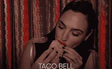 Gal Gadot eats the taco and then suddenly goes wide-eyed