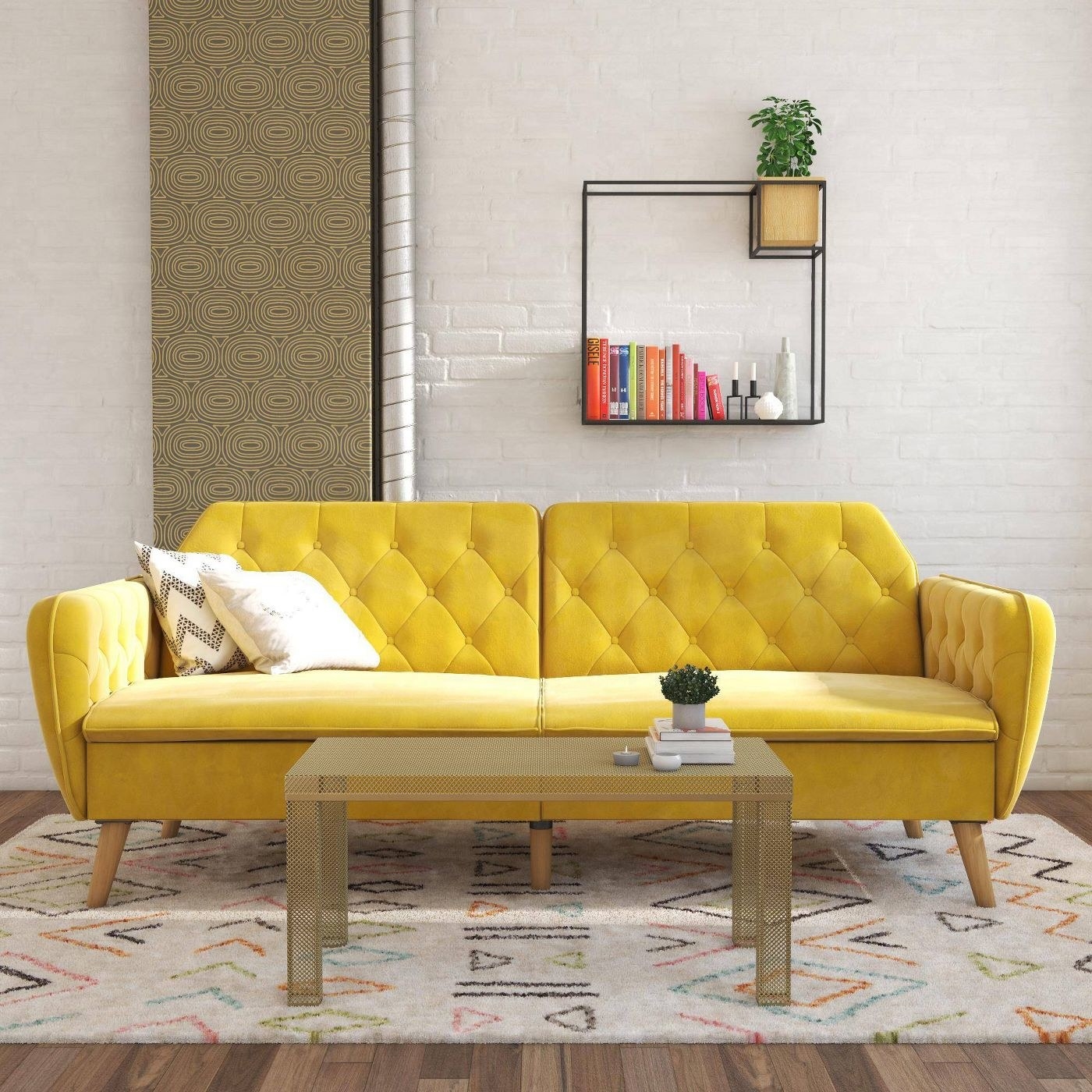 The sofa in yellow shown in a room with a rug and coffee table