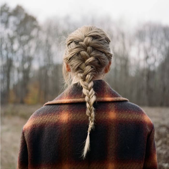 &quot;evermore&quot; album cover showing the back of Swift&#x27;s head and shoulders