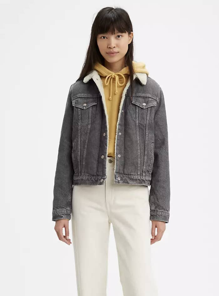 Model in gray trucker jacket with ivory lining 