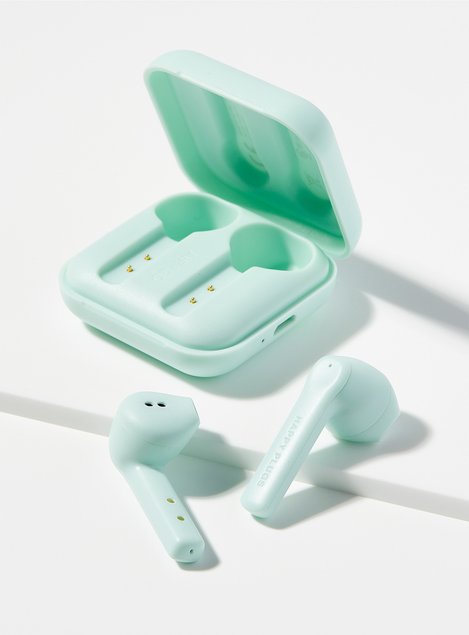 A pair of earpods and a small case beside them