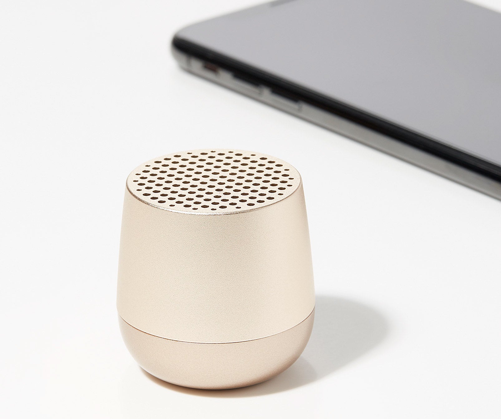 A small Bluetooth speaker on a plain background