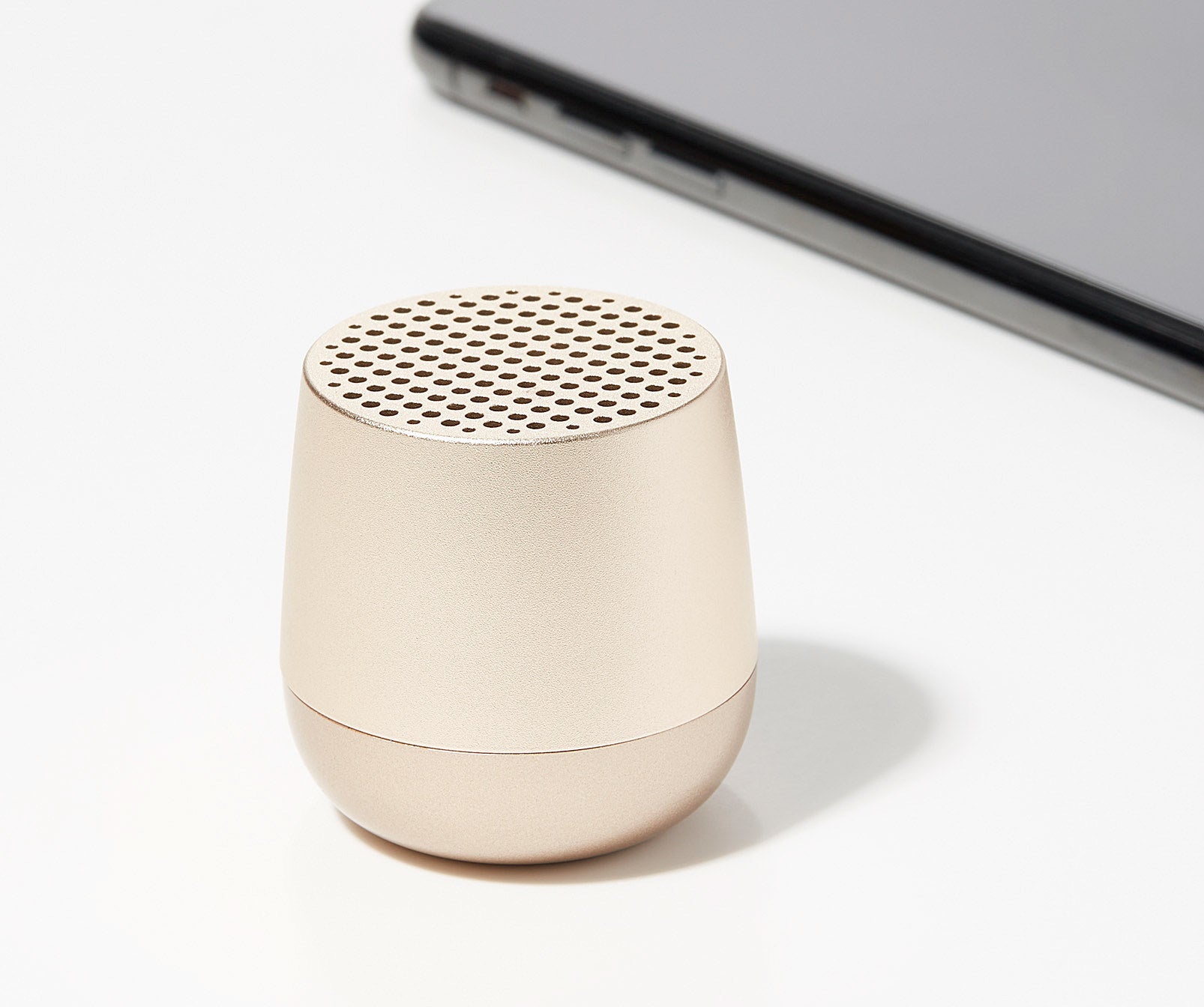 A small Bluetooth speaker on a plain background
