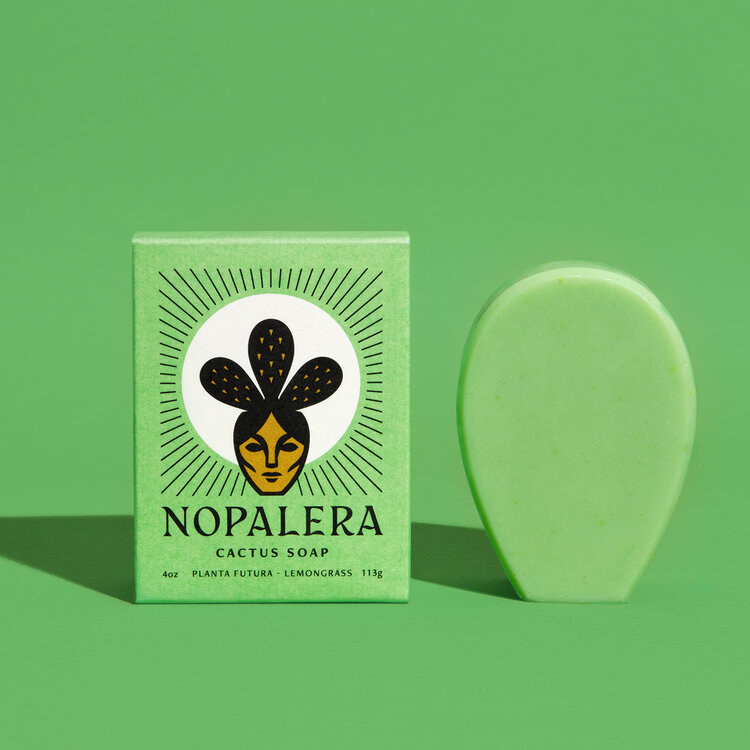 soap shaped like the node of a cactus next to box with character with cactus hair 