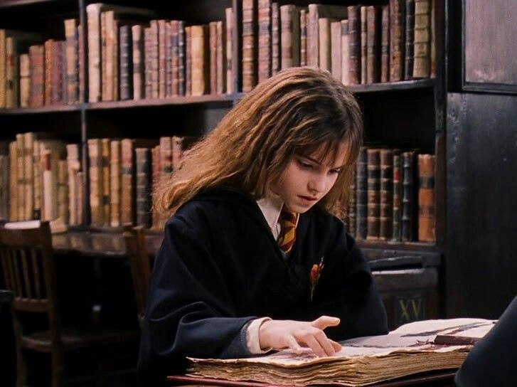 Hermione intensely reading a spell book 