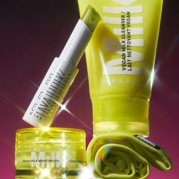 Milk Makeup&#x27;s After Party Skincare Set  with yellow containers, jars, and a yellow headband