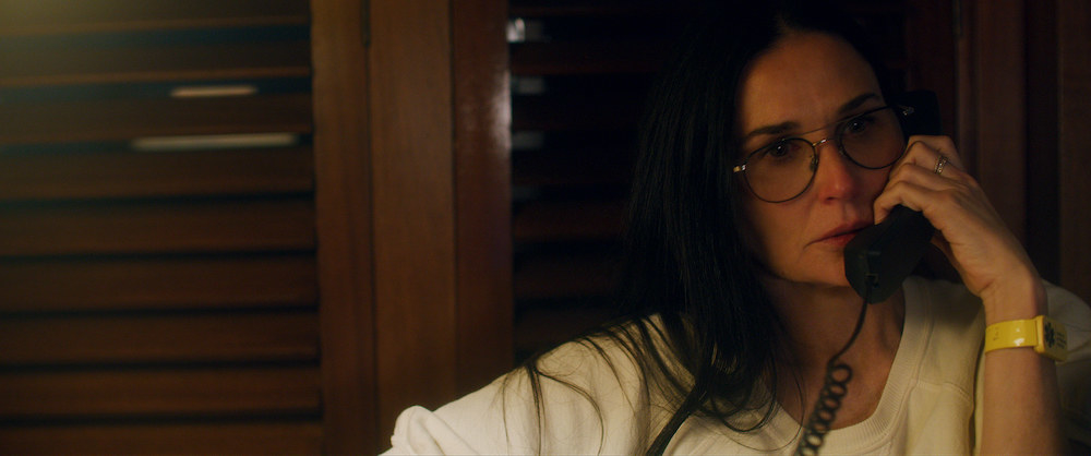 A shot from the film shows Demi Moore speaking on the phone