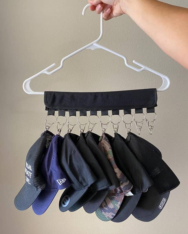 reviewer photo showing a hanging hat organizer with several baseball caps on it