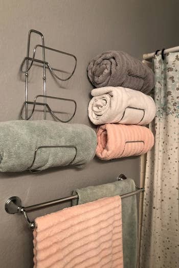 reviewer photo of the towel racks hanging on their bathroom wall