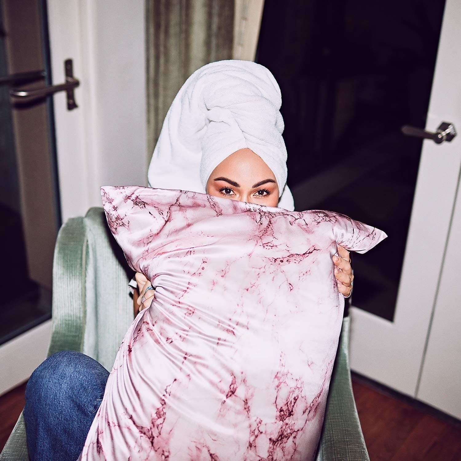 A model holding the pillowcase in pink marble