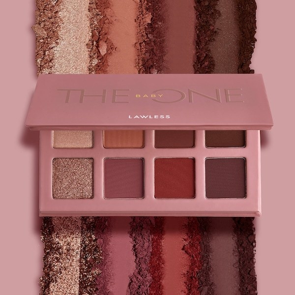 The eye shadow palette shown open and spread over a surface
