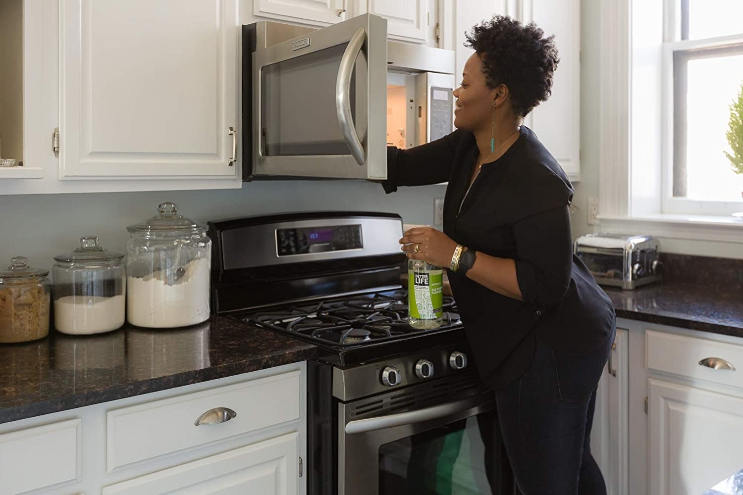 Model uses Better Life Natural All-Purpose Cleaner to clean inside of microwave