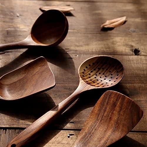 A wooden ladle, two spatulas, and a straining spoon