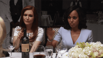 Olivia from &quot;Scandal&quot; pouring a big glass of red wine into her glass at dinner