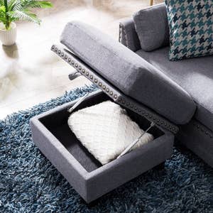 the ottoman part of couch opens up to revel storage with blanket in it