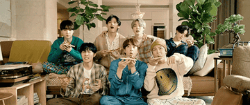 BTS eats pizza as they watch TV