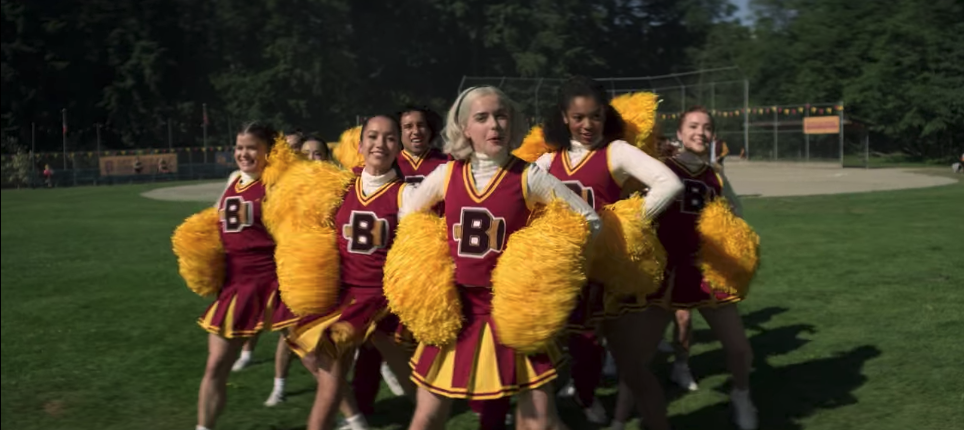Sabrina and the rest of the cheerleaders performing a pep rally