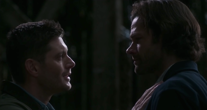 A closeup of Dean tearfully talking to Sam