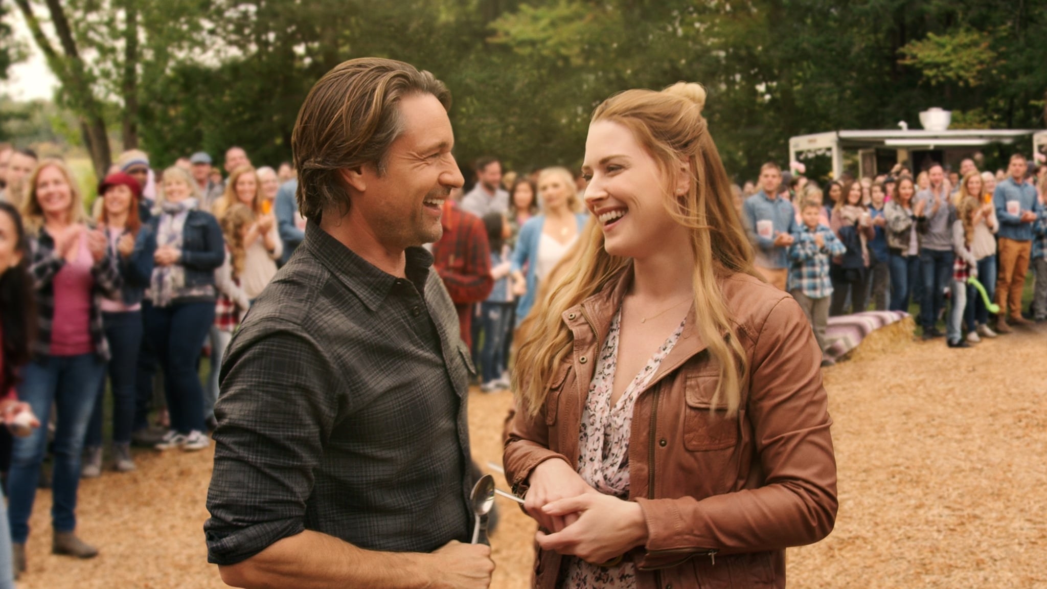 Jack Sheridan and Mel Monroe standing near each other at a country festival