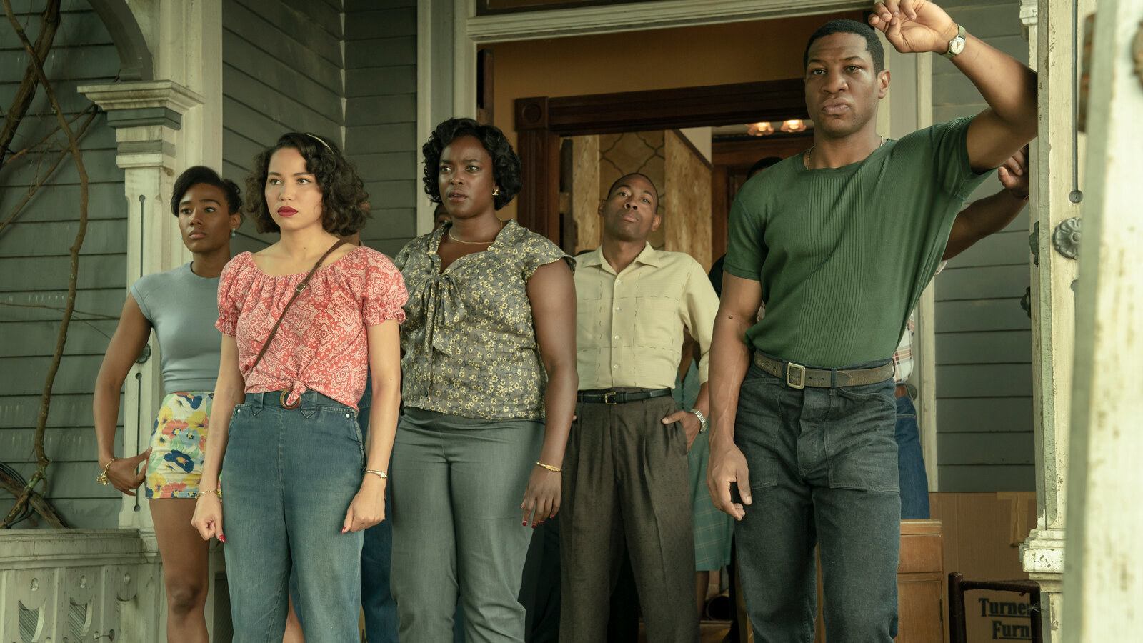 Characters in &quot;Lovecraft Country&quot; looking into the distance while standing on a porch 