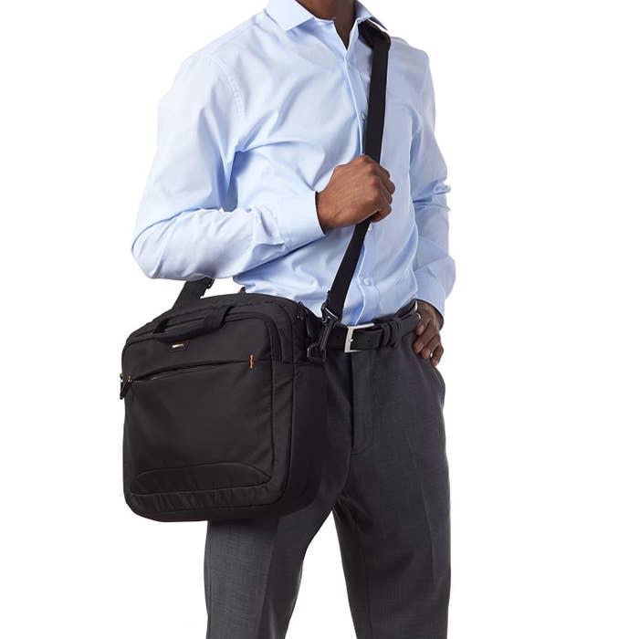 A man with a laptop bag slung across his shoulders