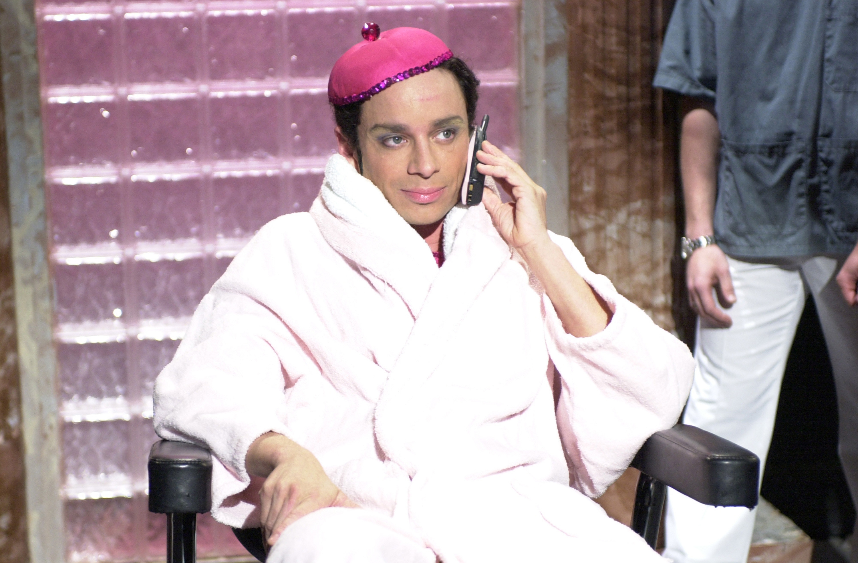 Chris Kattan as Mango in a robe sitting in a chair while talking on a cell ...