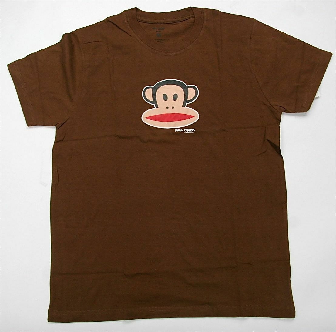 A brown T-shirt with a cartoon monkey head on it