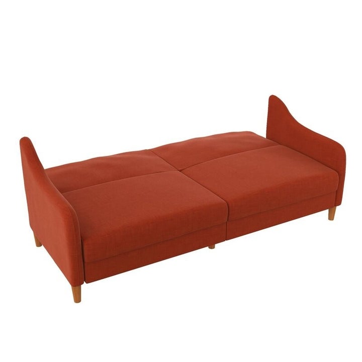The couch folded flat, with the back extended to create a bed the size of four large couch cushions