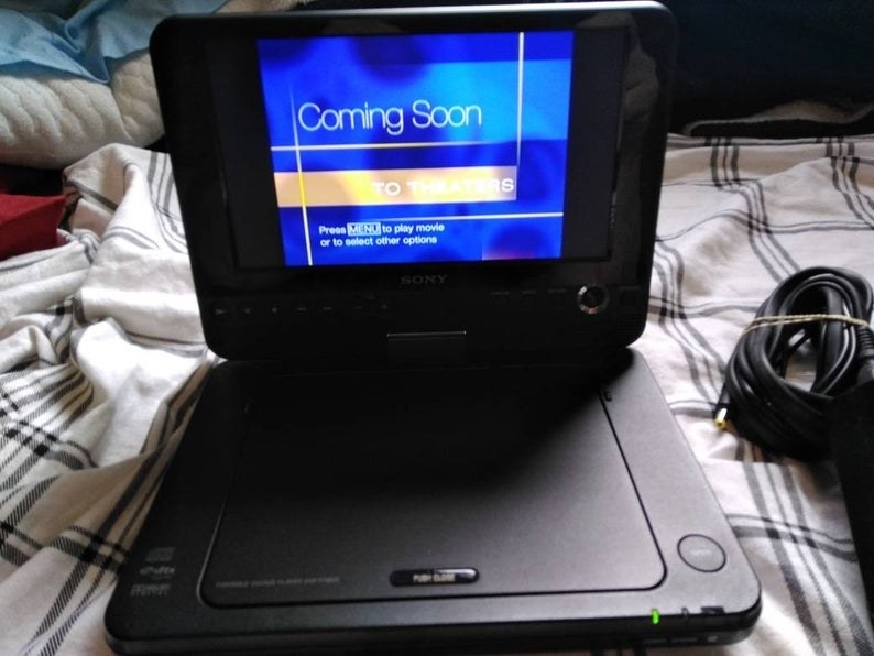 A portable DVD player opened and playing a Disney movie