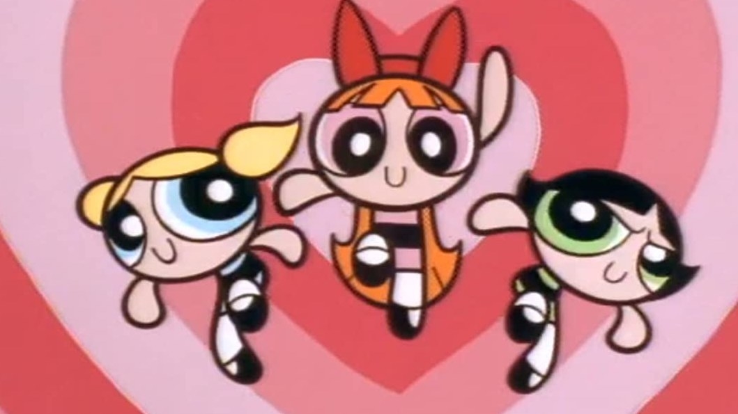 The Powerpuff Girls fly together in front of a background of love hearts