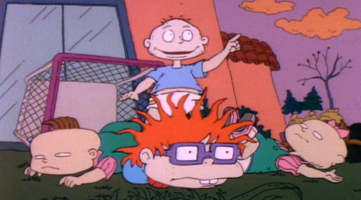 Tommy stands over Chuckie, Phil and Lil lying down