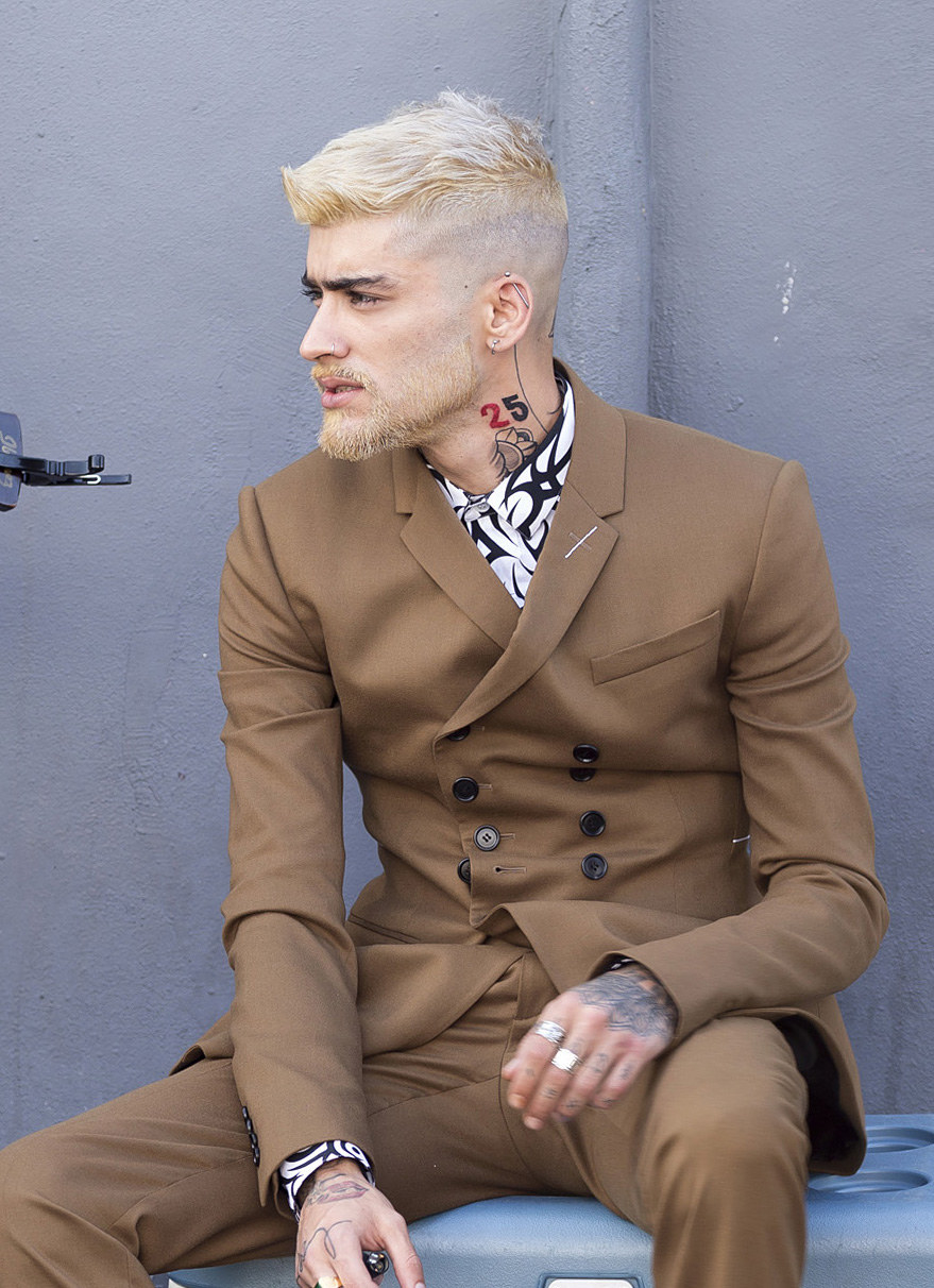 Zayn Malik shows off his latest tattoos and new blonde hair and beard during a video shoot in Miami, Florida. 