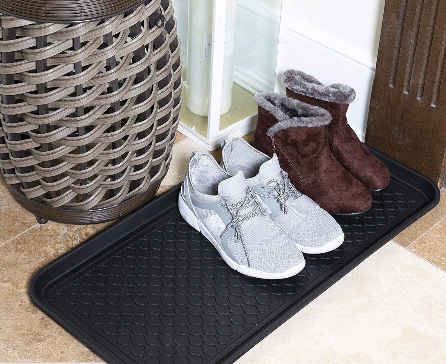 The tray with boots and sneakers on top of it
