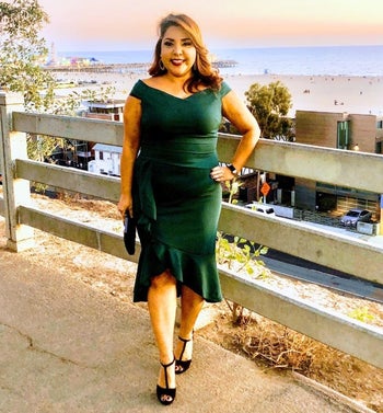 A different reviewer wearing the dress in green